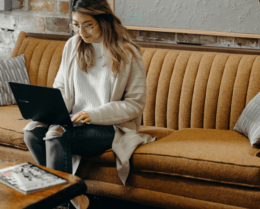 Woman using laptop while sitting on a couch